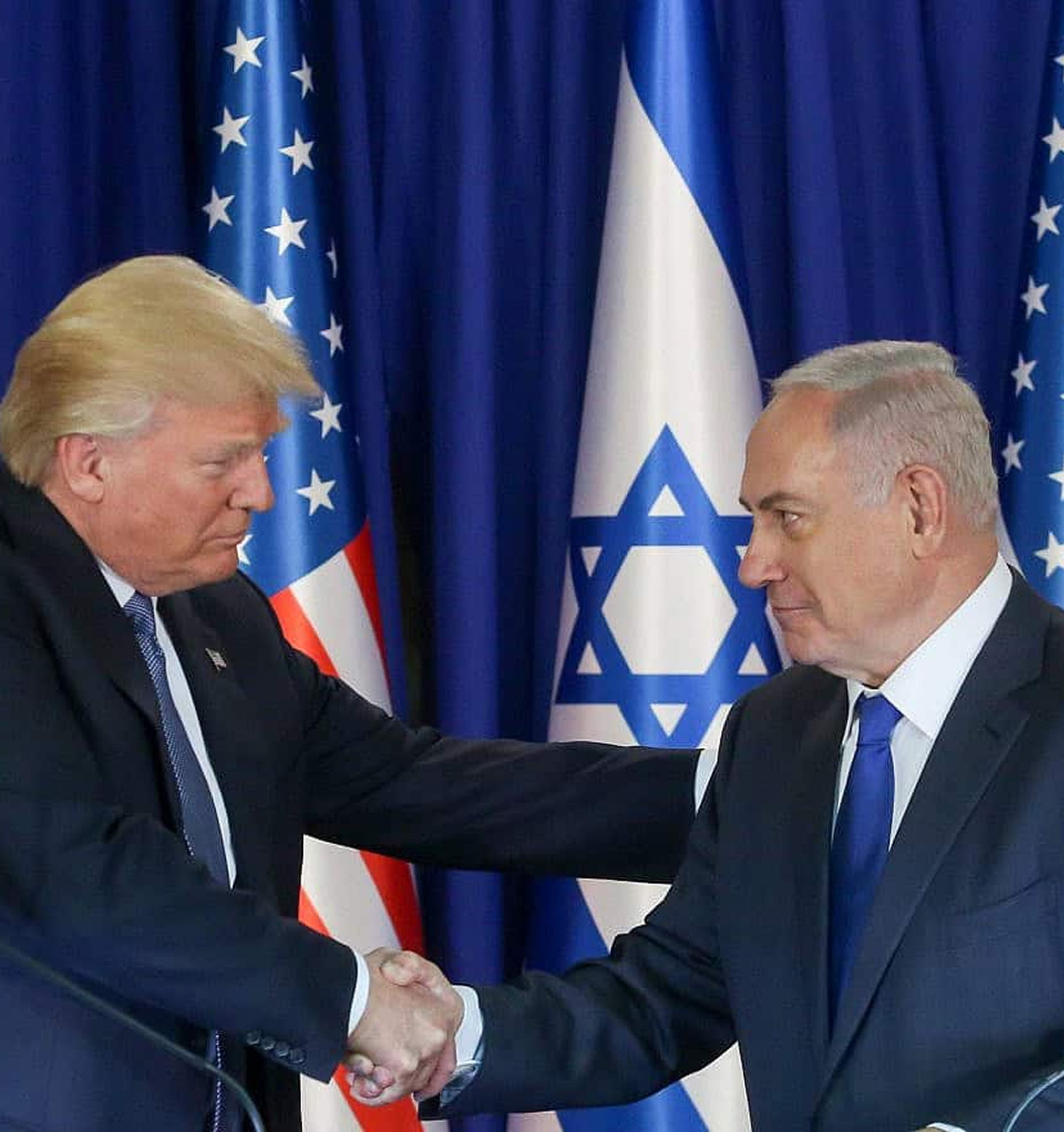 Two political leaders shaking hands in front of American and Israeli flags - sermons on the rapture