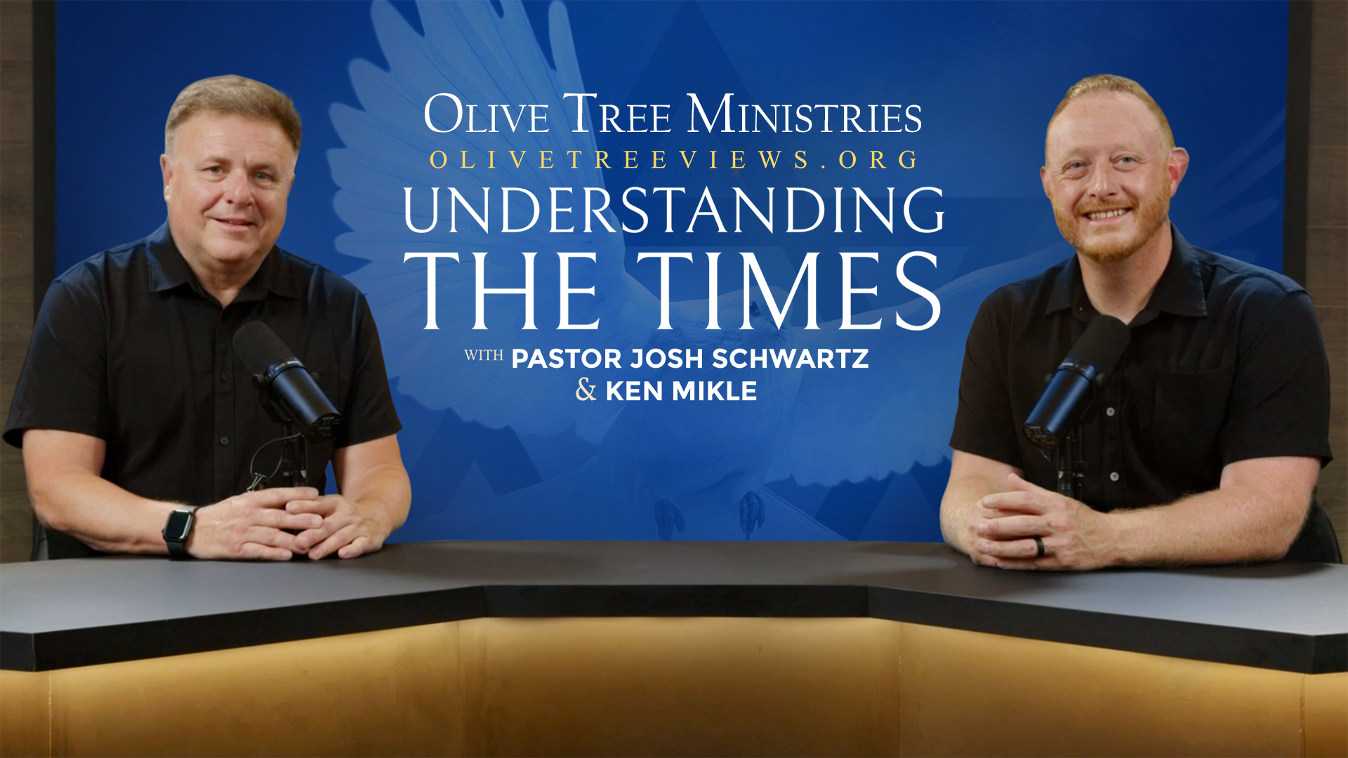 two men smiling behind microphones on a desk - bible study end times