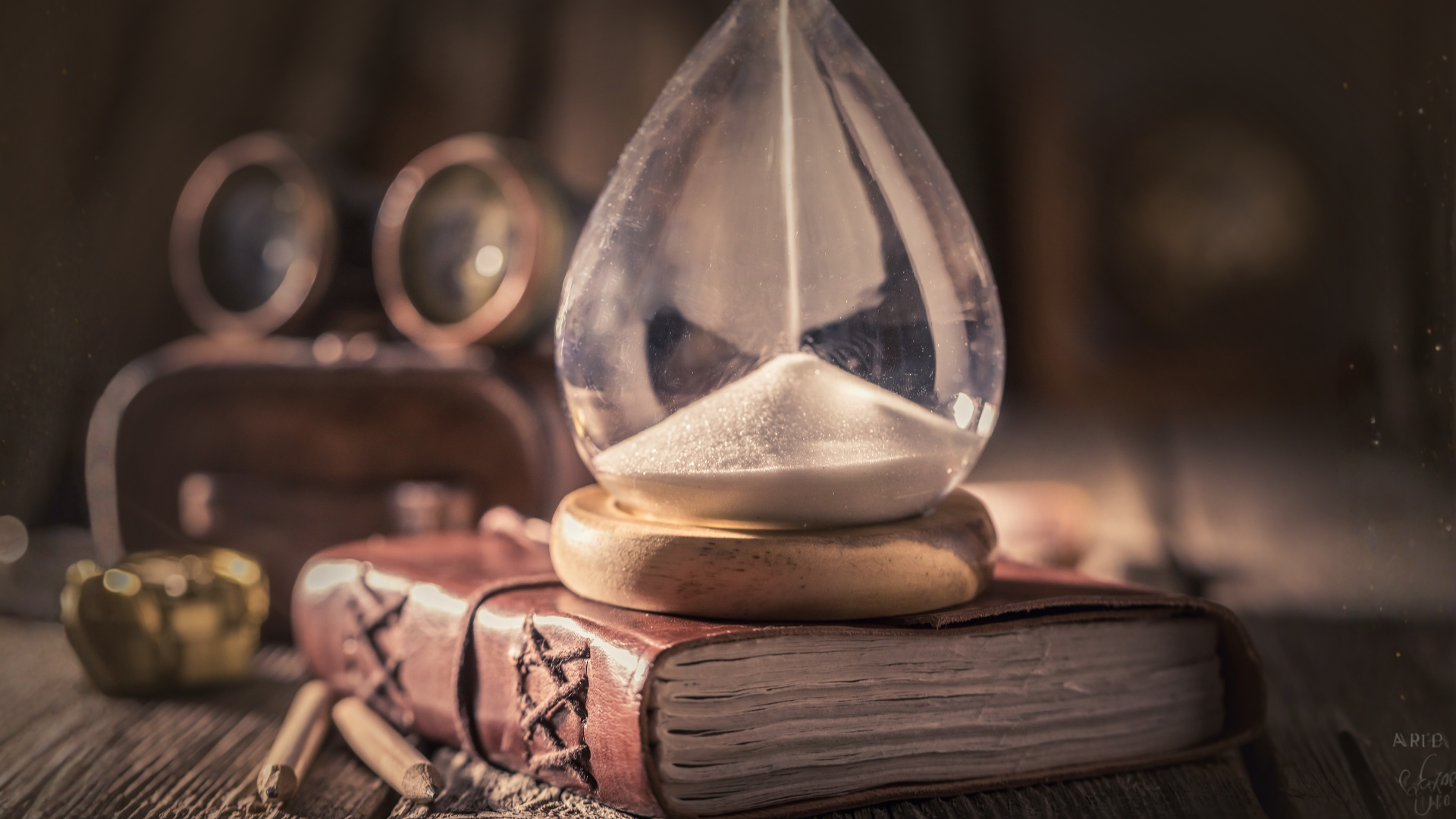 Hourglass resting on a stack of old books - prophecy in the end times